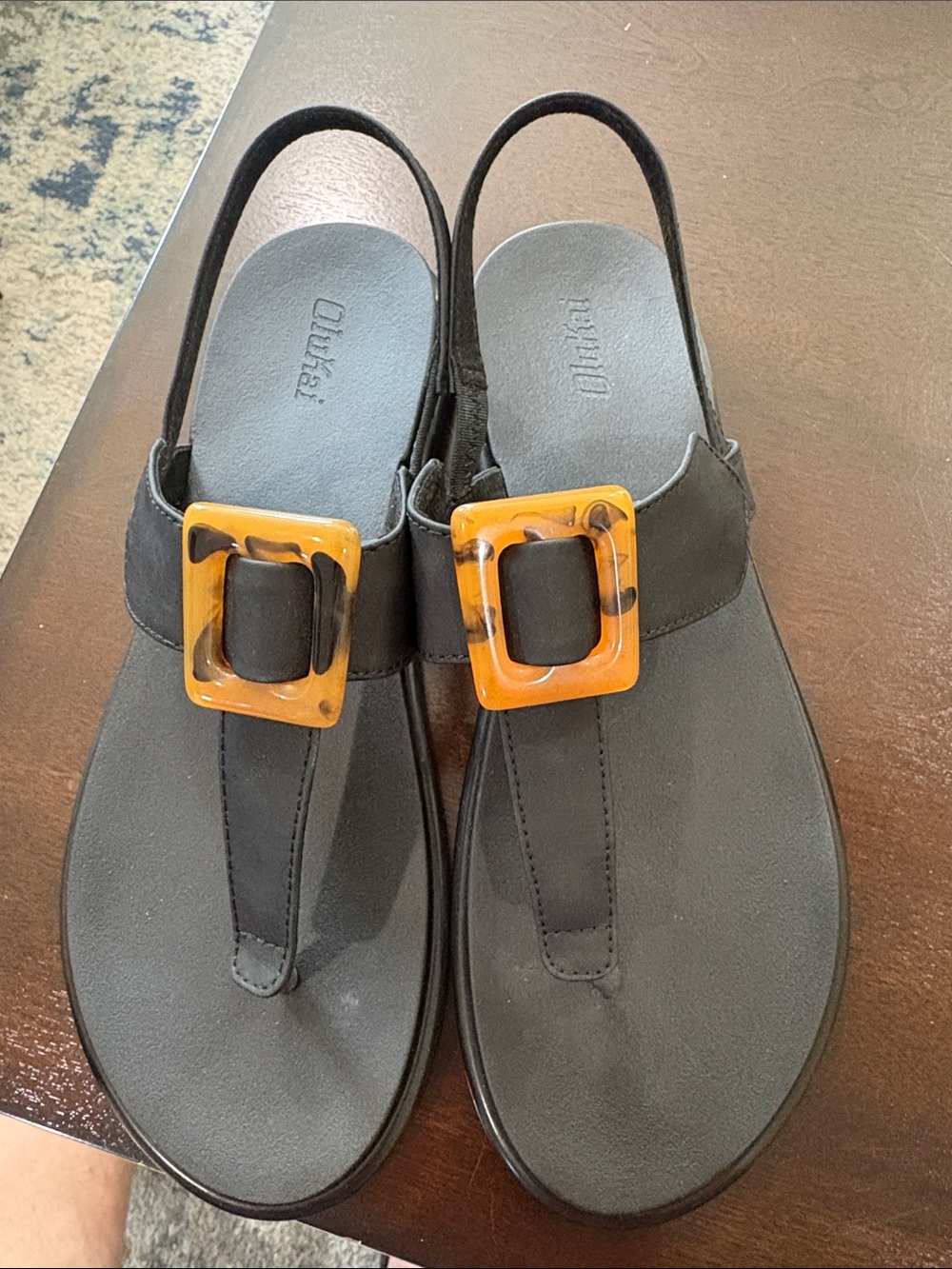 OluKai Black T-Strap Sandals with Amber Tortoiseshell Buckles